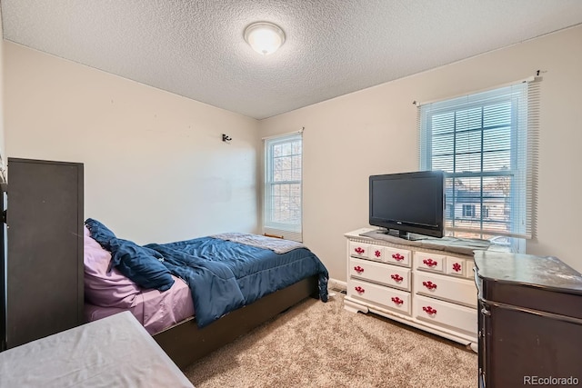 carpeted bedroom featuring a textured ceiling