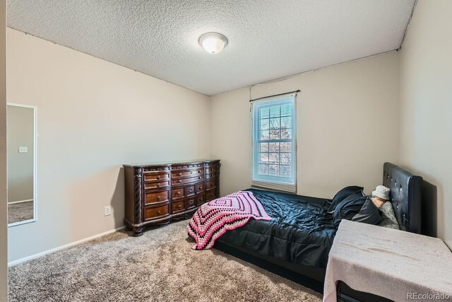 carpeted bedroom with a textured ceiling