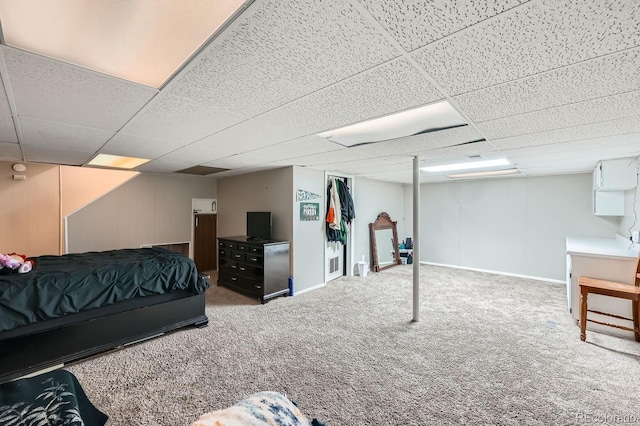 bedroom with a paneled ceiling and carpet flooring