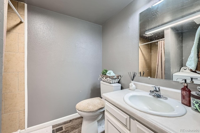 bathroom with curtained shower, hardwood / wood-style flooring, toilet, and vanity