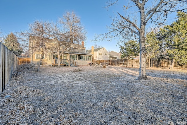 back of property with a wooden deck