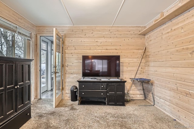 carpeted living room with wooden walls