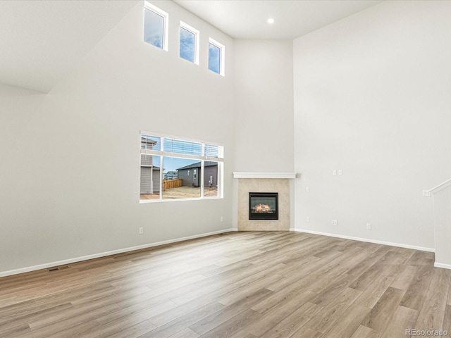 unfurnished living room with a healthy amount of sunlight and light hardwood / wood-style floors