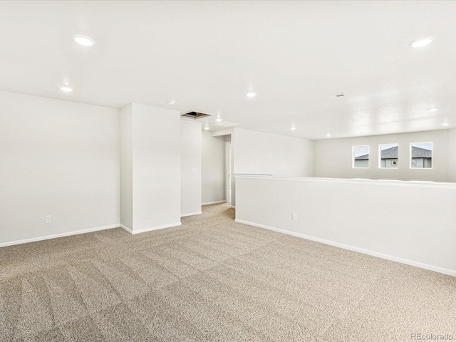 basement featuring light carpet