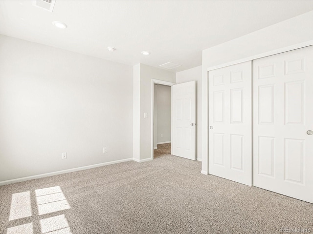 unfurnished bedroom featuring a closet and carpet flooring