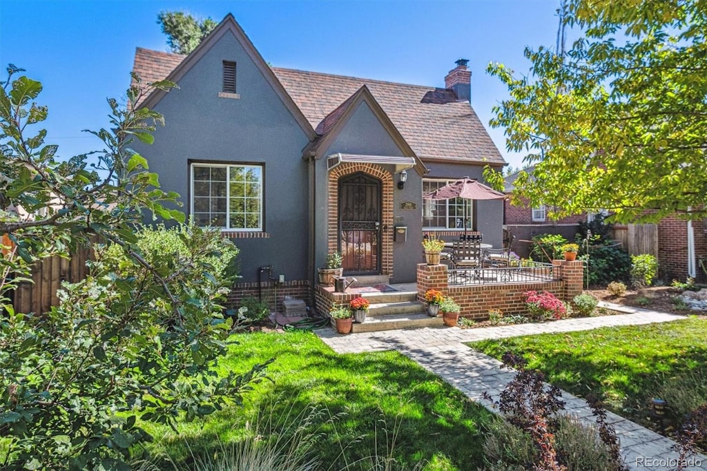 tudor house featuring a front yard