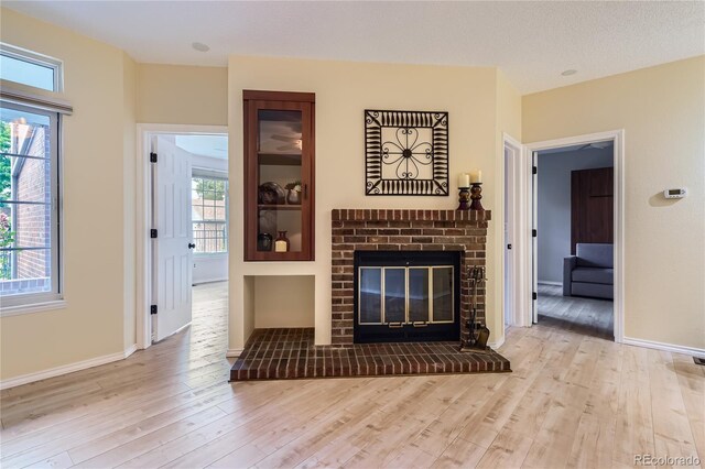 3040 W Prentice Ave Unit B, Littleton, CO 80123 - living room featuring wood finished floors and a brick fireplace