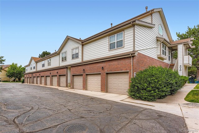 3040 W Prentice Ave Unit B, Littleton, CO 80123 - view of side of property featuring brick siding and community garages