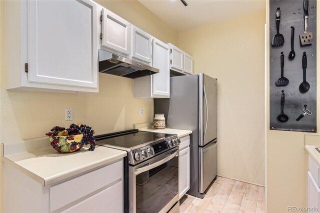 3040 W Prentice Ave Unit B, Littleton, CO 80123 - kitchen with under cabinet range hood, stainless steel electric range, white cabinets, light wood-type flooring, and light countertops