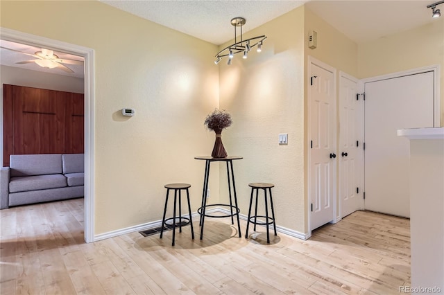 3040 W Prentice Ave Unit B, Littleton, CO 80123 - foyer entrance with wood finished floors, a ceiling fan, and a textured wall