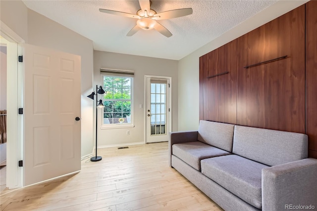 3040 W Prentice Ave Unit B, Littleton, CO 80123 - living room featuring a ceiling fan, light wood-style flooring, and a textured ceiling