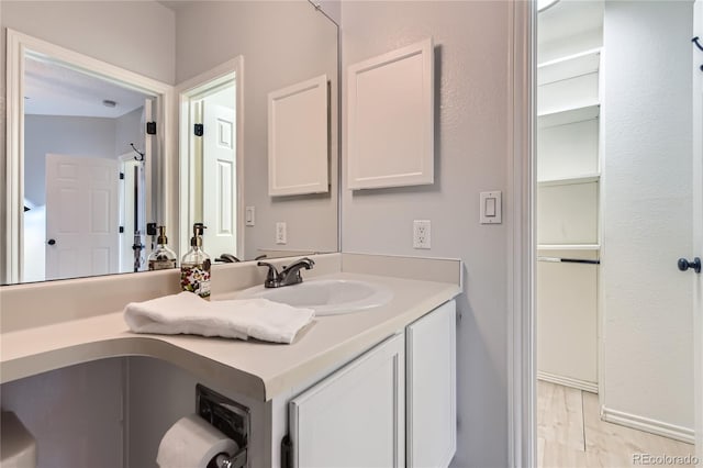 3040 W Prentice Ave Unit B, Littleton, CO 80123 - bathroom featuring vanity and wood finished floors
