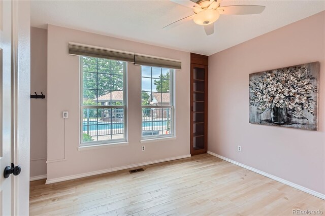 3040 W Prentice Ave Unit B, Littleton, CO 80123 - empty room with light wood-style flooring, healthy amount of natural light, and a ceiling fan