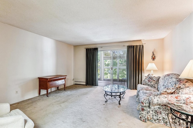 living room with light carpet, a baseboard heating unit, and a textured ceiling