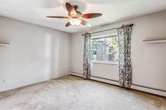 carpeted empty room featuring ceiling fan, baseboard heating, and a textured ceiling