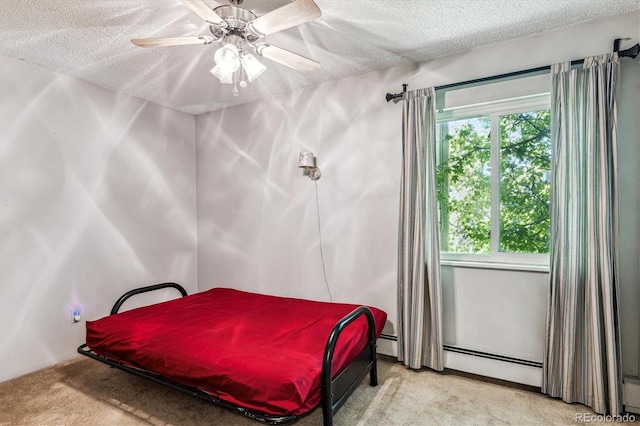 carpeted bedroom featuring a textured ceiling, baseboard heating, and ceiling fan