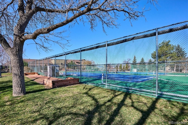 view of tennis court with a lawn