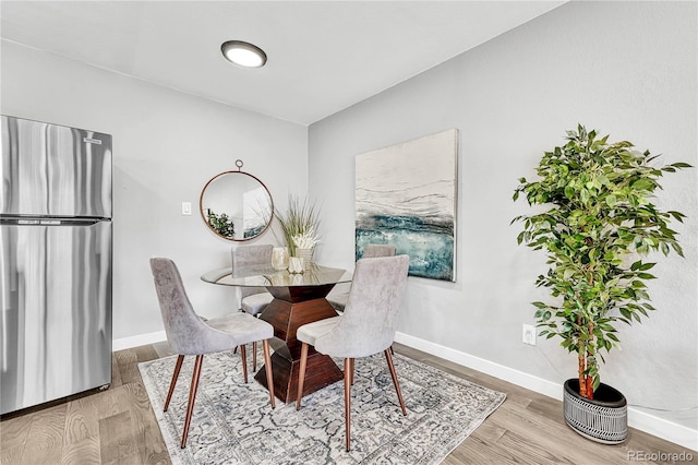 dining space with light hardwood / wood-style floors