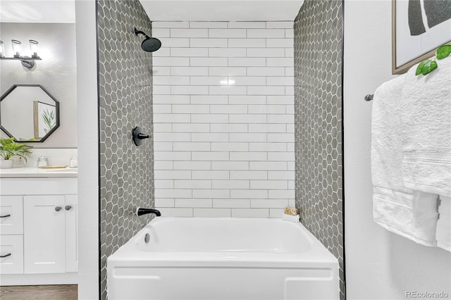 bathroom featuring vanity and tiled shower / bath combo