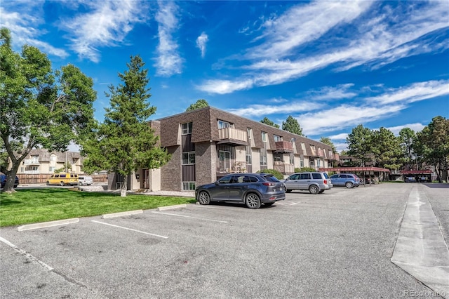 view of car parking with a lawn