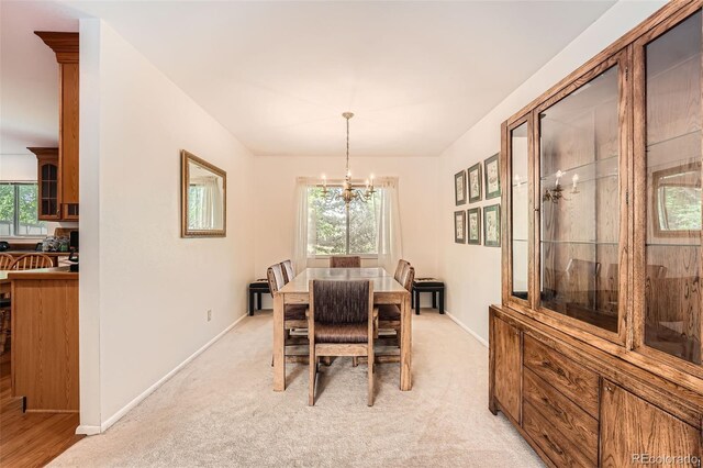 13934 W Warren Dr, Lakewood, CO 80228 - dining room with a chandelier, plenty of natural light, and light colored carpet