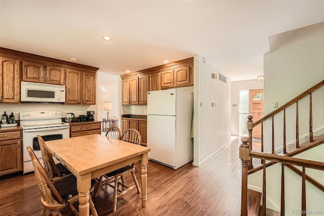 13934 W Warren Dr, Lakewood, CO 80228 - kitchen with white appliances, recessed lighting, dark wood-type flooring, and brown cabinetry