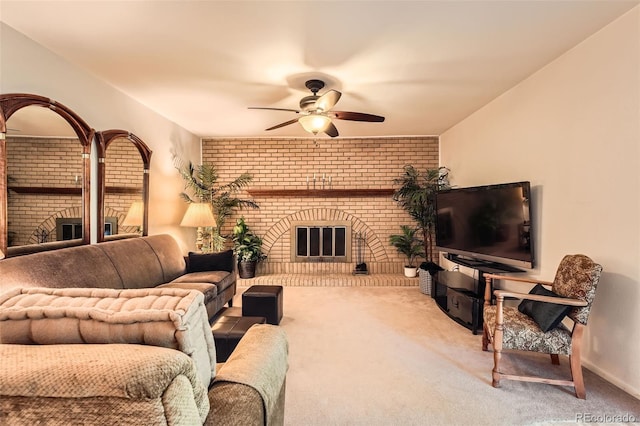 13934 W Warren Dr, Lakewood, CO 80228 - carpeted living area with a brick fireplace, brick wall, and a ceiling fan