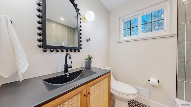 bathroom featuring vanity and toilet