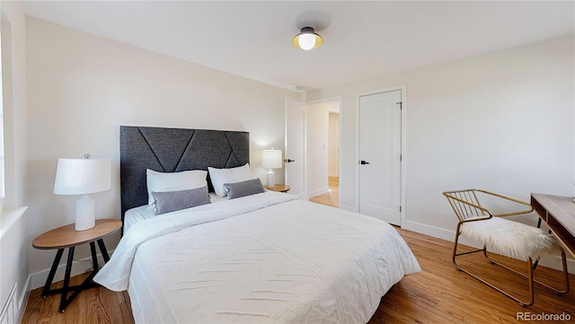 bedroom featuring hardwood / wood-style floors and a closet