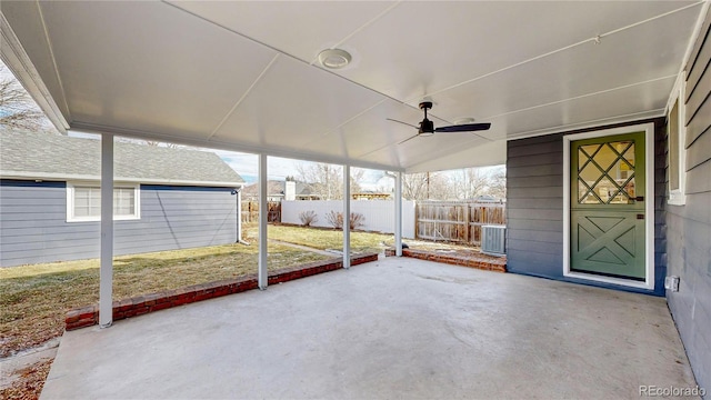 unfurnished sunroom featuring ceiling fan