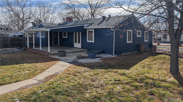 view of front of house with a patio area and a front yard