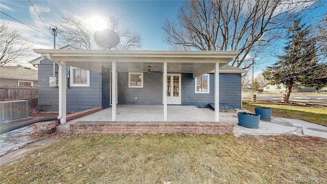 rear view of property with a lawn, central AC unit, ceiling fan, and a patio area