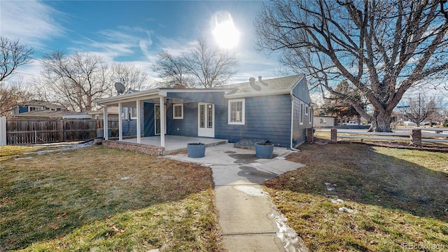 view of front of property with a patio and a front yard