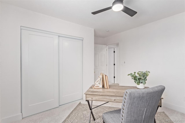 carpeted office featuring ceiling fan