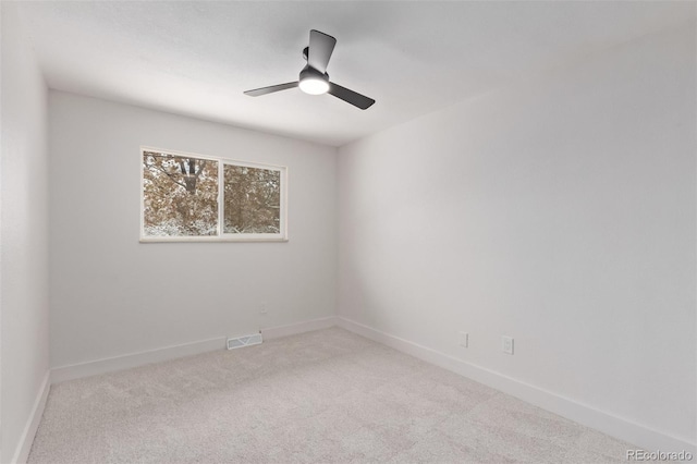 carpeted spare room featuring ceiling fan