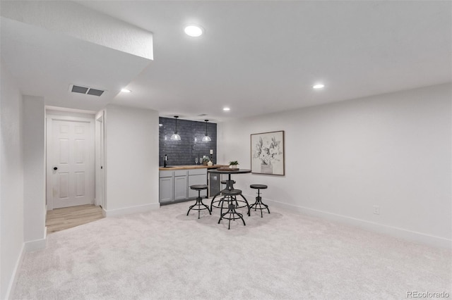 interior space with light carpet and indoor wet bar