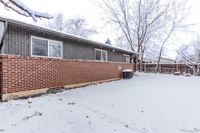 view of snow covered rear of property