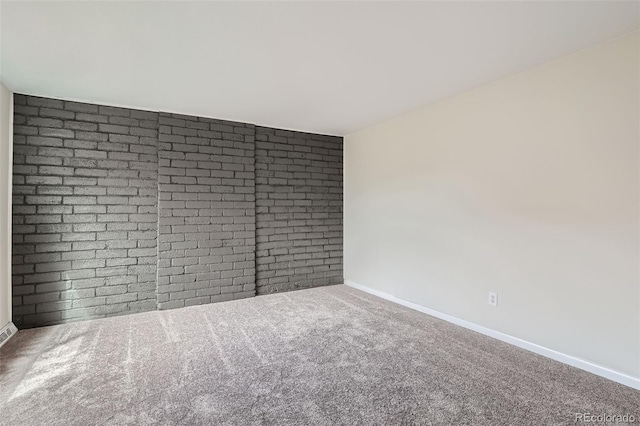 carpeted spare room with baseboards