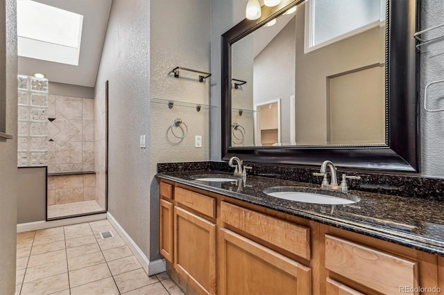 bathroom featuring vanity, a tile shower, and tile patterned floors