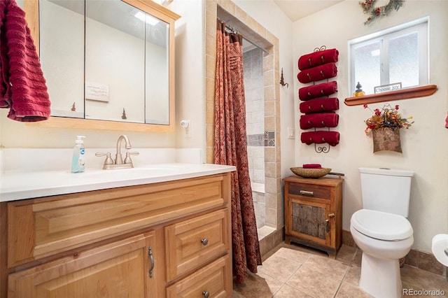 bathroom featuring curtained shower, tile patterned flooring, toilet, and vanity