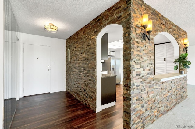 foyer featuring dark hardwood / wood-style floors and a textured ceiling