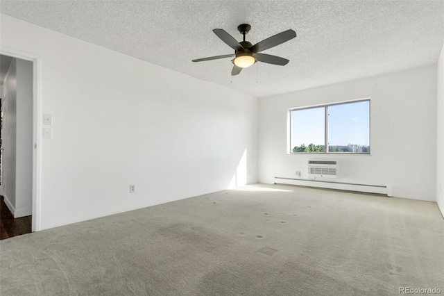 empty room featuring a wall mounted air conditioner, a baseboard radiator, a textured ceiling, and carpet flooring