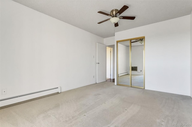 unfurnished bedroom with a baseboard radiator, light colored carpet, and a closet