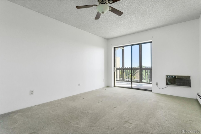 carpeted spare room featuring ceiling fan, a wall unit AC, and a textured ceiling