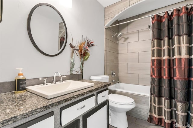 full bathroom featuring vanity, tile patterned floors, toilet, and shower / bath combo with shower curtain