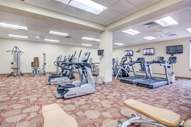 gym featuring a paneled ceiling and carpet