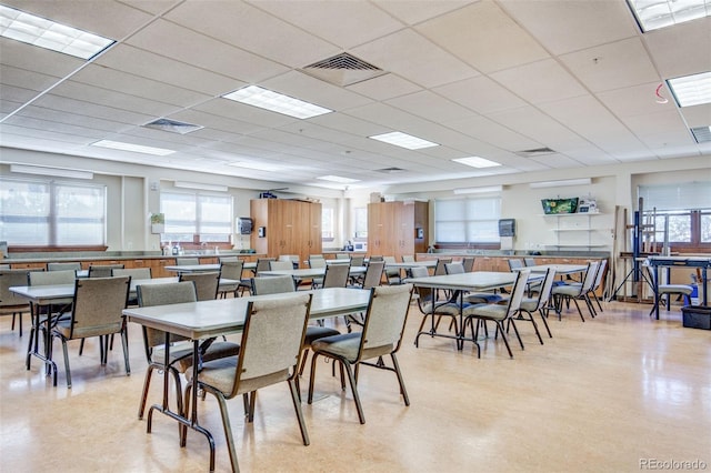 dining space with a drop ceiling