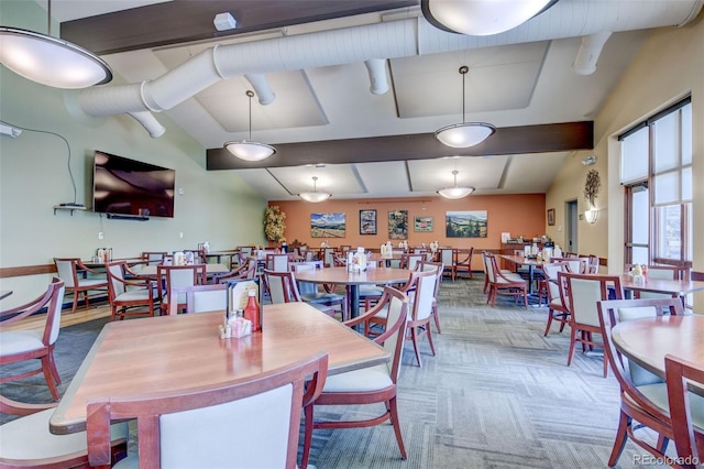 dining space featuring vaulted ceiling with beams and carpet