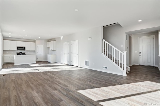 unfurnished living room featuring hardwood / wood-style flooring