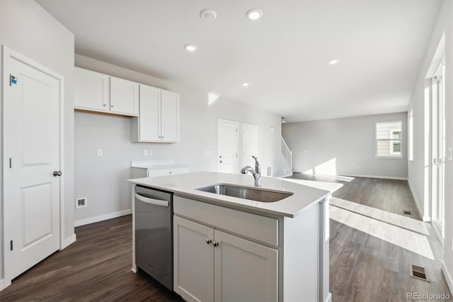 kitchen featuring dishwasher, a kitchen island with sink, dark wood-type flooring, white cabinets, and sink